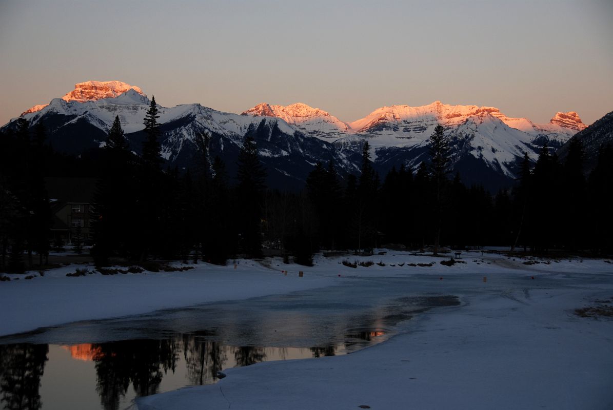22A Mount Bourgeau, Mount Brett, Massive Mountain and Pilot Mountain Glow In The First Rays Of Sunrise From Bow River Bridge In Banff In Winter